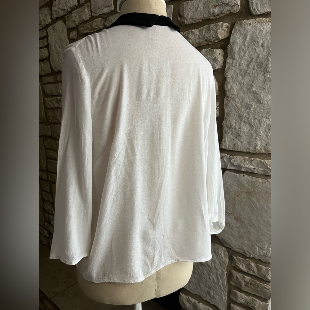 White blouse with black collar